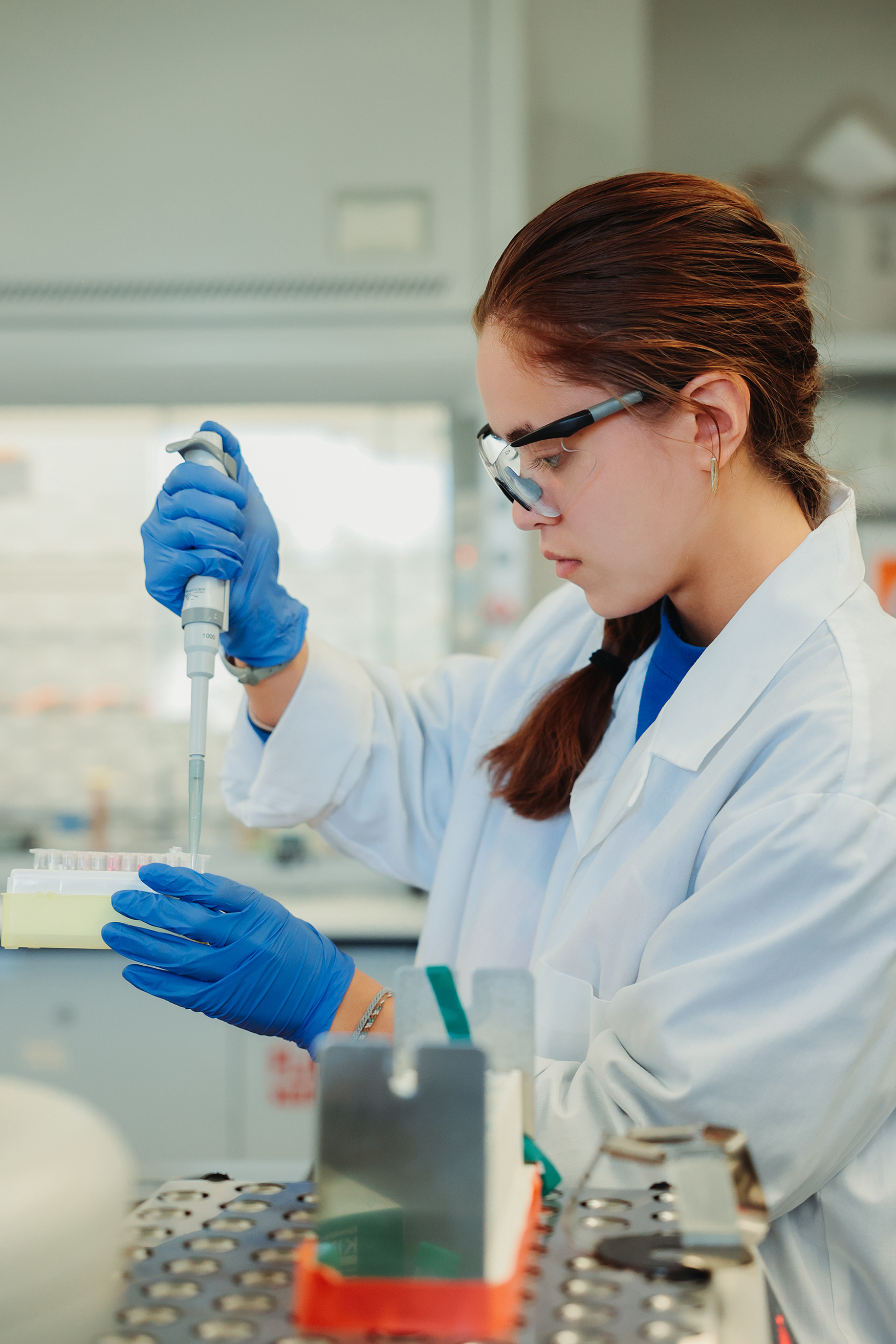 A student adding liquid to a vial